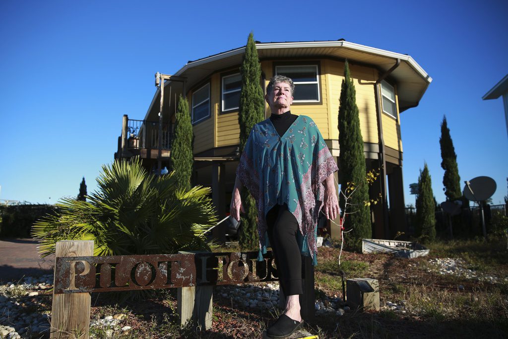 woman stands in front of hurricane resilient home