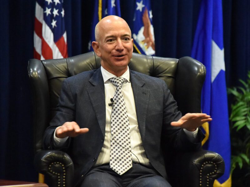 Jeff Bezos sitting in a chair on a stage